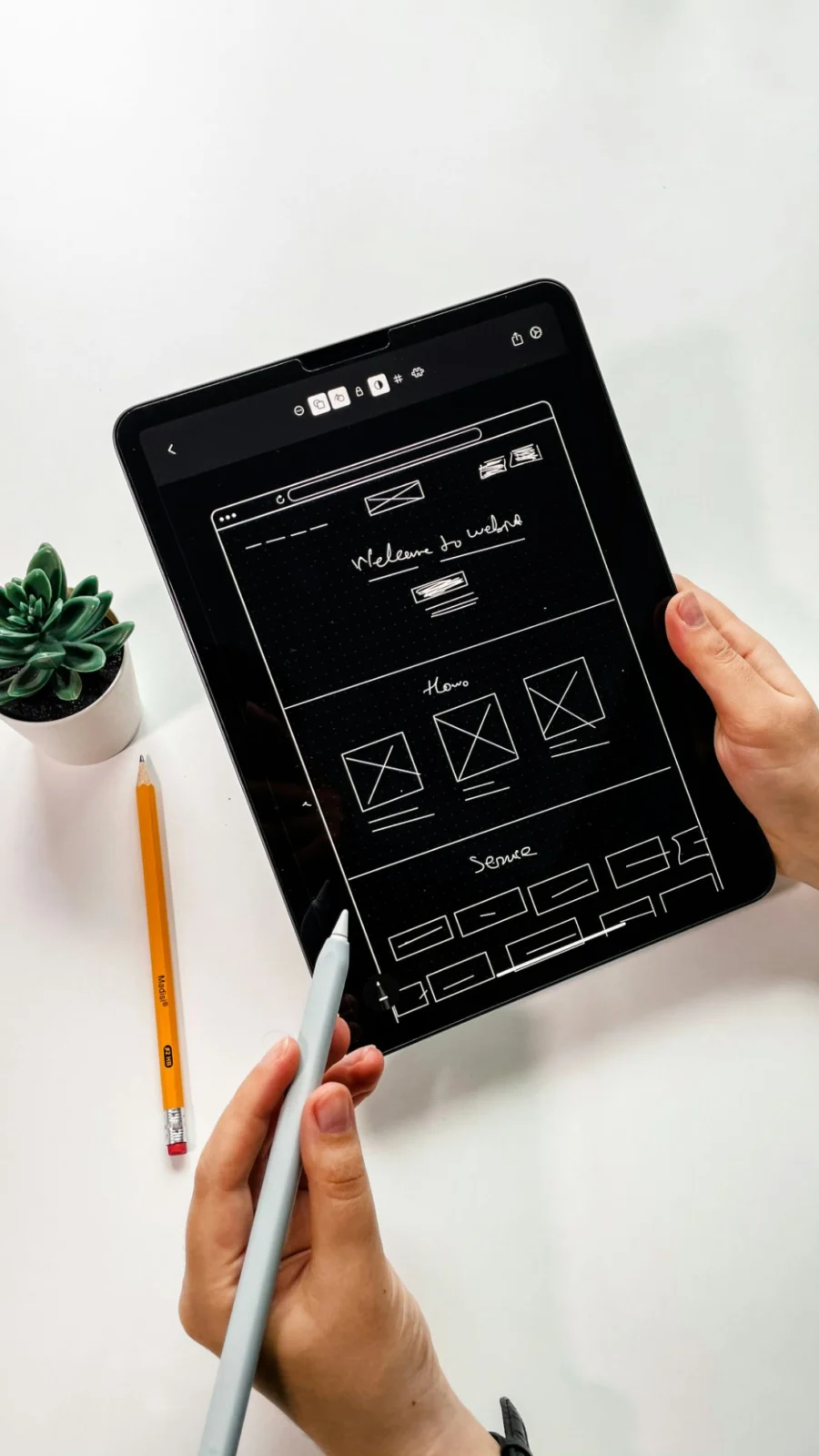 Website wireframe sketches on a tablet